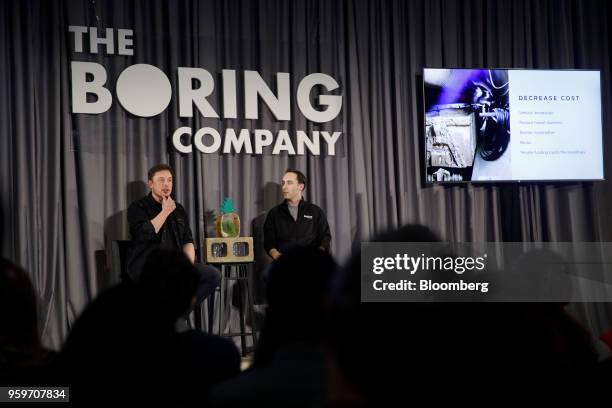 Elon Musk, co-founder and chief executive officer of Tesla Inc., left, speaks as Steve Davis, the operations head of Boring Co., right, listens...