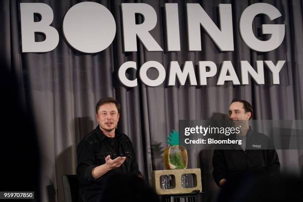 Elon Musk, co-founder and chief executive officer of Tesla Inc., left, speaks as Steve Davis, the operations head of Boring Co., listens during a...