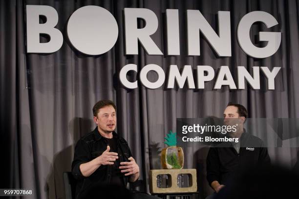 Elon Musk, co-founder and chief executive officer of Tesla Inc., left, speaks as Steve Davis, the operations head of Boring Co., listens during a...