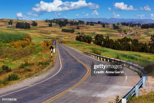winding two-lane road through farmland between cusco city and moray, peru, autumn afternoon - moray cusco fotografías e imágenes de stock
