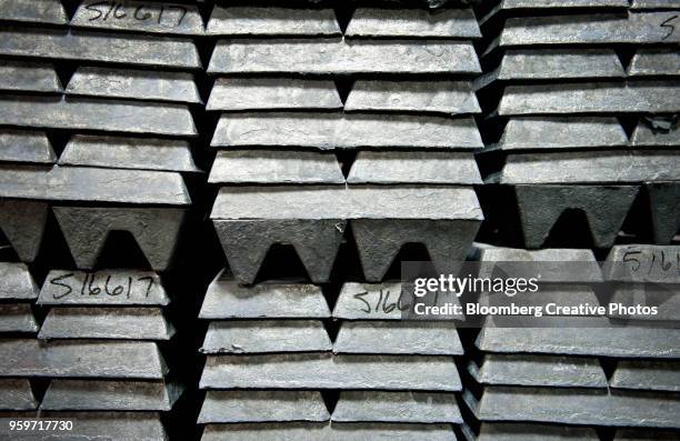 zinc ingots, used to coat galvanized nails, sit stacked in a warehouse - zinc stock pictures, royalty-free photos & images