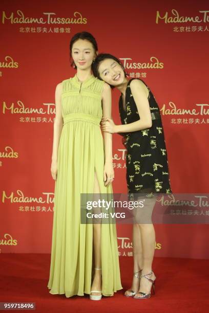 Actress Zhou Dongyu poses with her wax figure during the unveiling ceremony at Madame Tussauds on May 18, 2018 in Beijing, China.