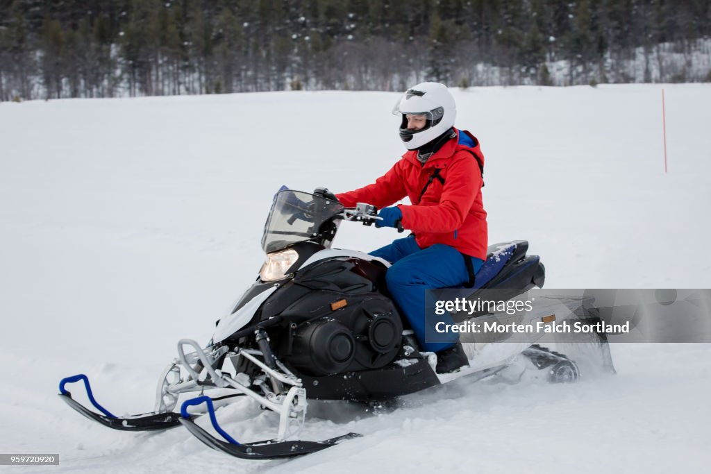 A Man Drives a Snowmobile on a Mountain in Rural Norway, Wintertime