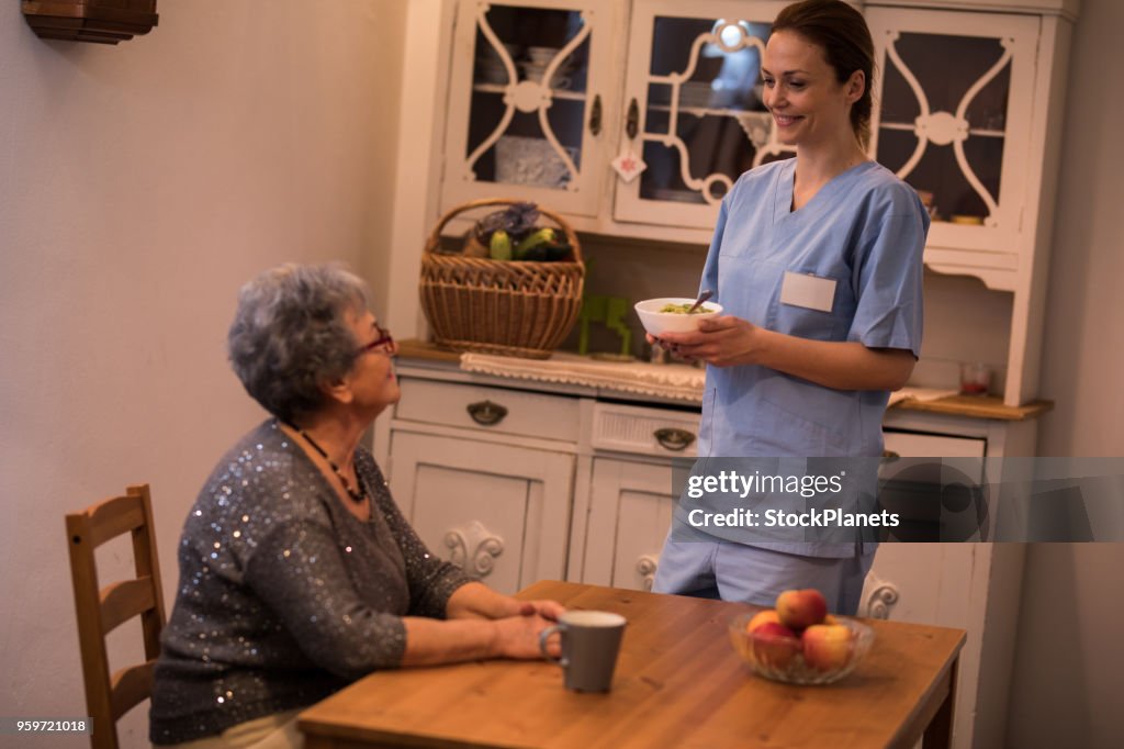 Homecare nurse with senior women in kitchen