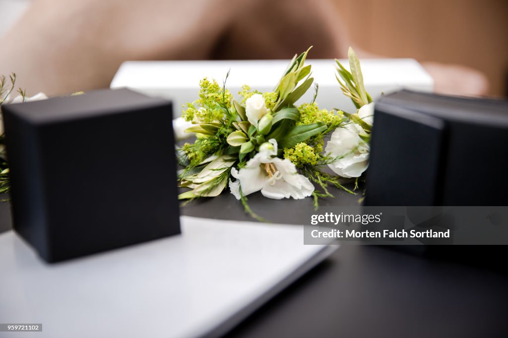 Close-Up Shot of Boutonnières and Jewelry Boxes on a Table during Wedding Celebrations in Berlin, Germany Summertime