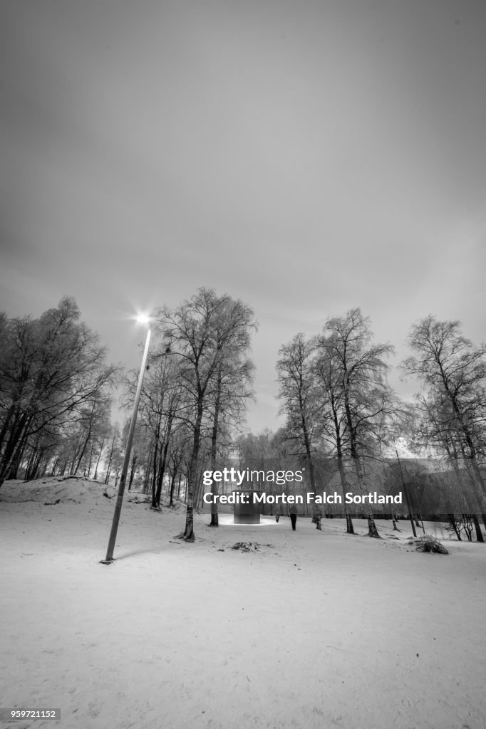 Black and White Shot of a Small Wooden Outbuilding in the Snowy Forested Area of Sognsvann Lake, Norway Wintertime