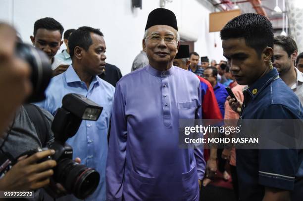 Malaysia's former prime minister Najib Razak walks after Friday prayers at the Barisan Nasional party headquarters in Kuala Lumpur on May 18, 2018. -...