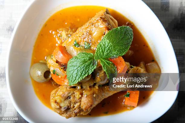 orange and saffron chicken tagine - chicken stew stock pictures, royalty-free photos & images
