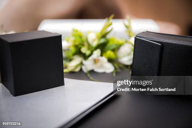 close-up shot of boutonnières and jewelry boxes on a table during wedding celebrations in berlin, germany summertime - corsage stock pictures, royalty-free photos & images