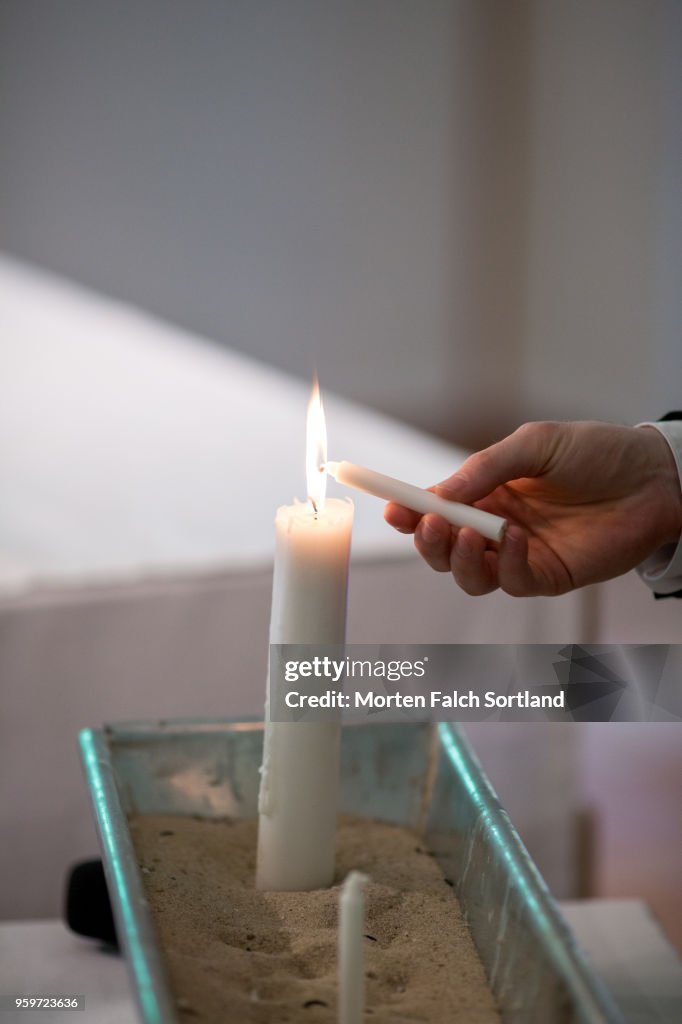 A Man Lights a Candle in a Church during a Wedding Ceremony in Berlin, Germany Summertime