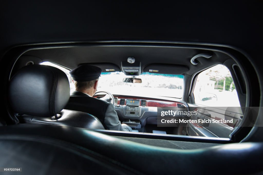 A Smartly Dressed Man Drives a Limo to a Wedding Ceremony in Berlin, Germany Summertime