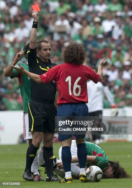 Referee Mark Geiger shows the red card to Manuel Iturra of Chile during their friendly footbal match againts Mexico before their departure for South...