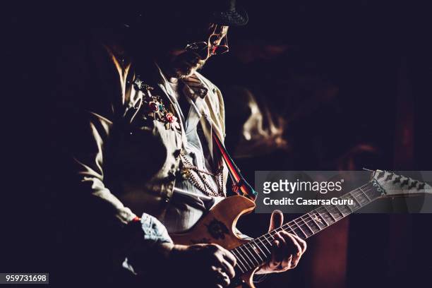 senior rock guitarist performing - rock star stock pictures, royalty-free photos & images