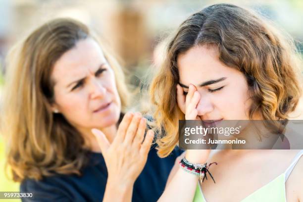 mature mother scolding her young daughter - angry parent stock pictures, royalty-free photos & images
