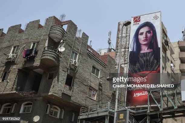 Billboards for TV Ramadan series are seen in the streets of the Egyptian capital Cairo on May 15, 2018. - Soaps and dramas normally united...