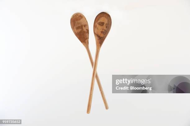 Pair of Prince Harry & Meghan Markle decorative wooden spoons, manufactured by SquirrelPigeonFish, sit in this arranged photo in London, U.K., on...
