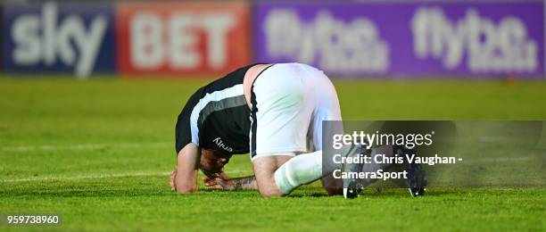 Lincoln City's Matt Rhead lays on the pitch after suffering a head injury during the Sky Bet League Two Play Off Semi Final:Second Leg between Exeter...