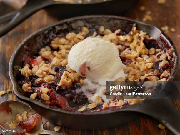 strawberry and blueberry crisp with vanilla ice cream - cobbler stock pictures, royalty-free photos & images