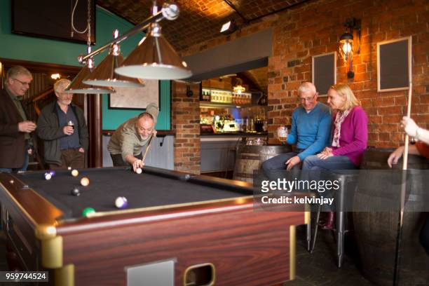 a group of friends playing pool in a bar - kelvinjay stock pictures, royalty-free photos & images