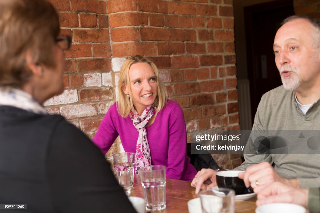 A group of friends drinking coffee in a bar