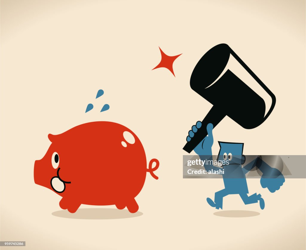 Businessman holding a big hammer and breaking the big piggy bank