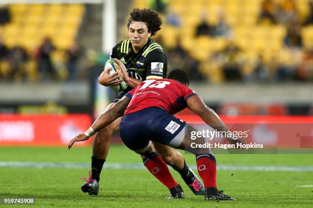 Peter Umaga-Jensen of the Hurricanes runs at Samu Kerevi of the Reds during the round 14 Super Rugby match between the Hurricanes and the Reds at...