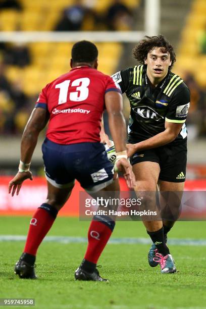 Peter Umaga-Jensen of the Hurricanes looks to evade Samu Kerevi of the Reds during the round 14 Super Rugby match between the Hurricanes and the Reds...