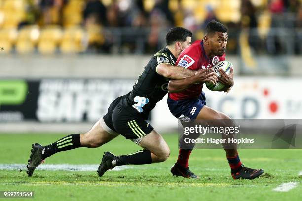 Aidan Toua of the Reds is tackled by Nehe Milner-Skudder of the Hurricanes during the round 14 Super Rugby match between the Hurricanes and the Reds...