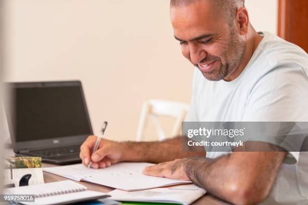 mature man working at home. - aboriginal man imagens e fotografias de stock