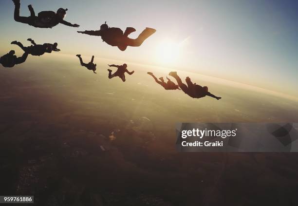 skydiving group at the sunset - skydiving pov stock pictures, royalty-free photos & images