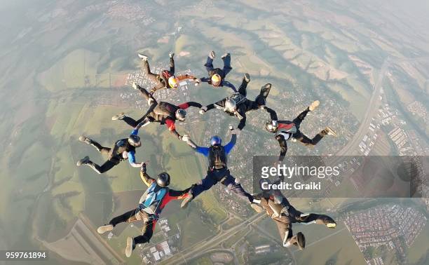 skydiving group at the sunset - extreme sports point of view stock pictures, royalty-free photos & images