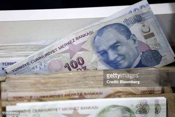 An image of Mustafa Kemal Attaturk, Turkey's founder, sits on a 100 Turkish lira banknote in a currency exchange in Istanbul, Turkey, on Friday, May...