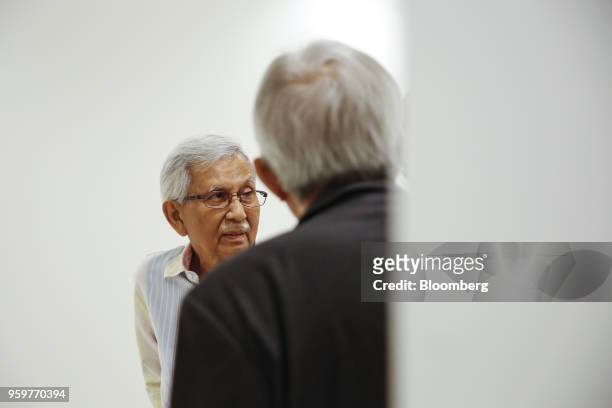 Daim Zainuddin, member of Prime Minister Mahathir Mohamad's advisory council, left, arrives for a news conference in Kuala Lumpur, Malaysia, on...