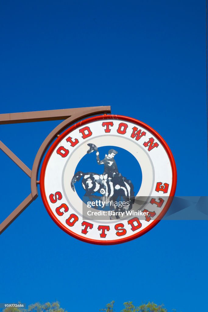 Sign with cowboy and horse above street in Old Town, Scottsdale, AZ