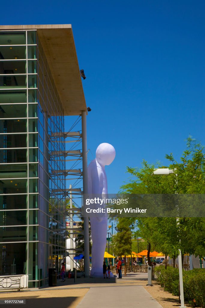 Oversize inflated balloon of a human against wall of Mesa, AZ art center