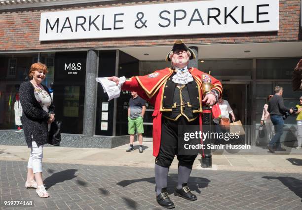 Town crier outside a Marks & Spencer store is that has had its name changed to 'Markle & Sparkle' ahead of the Royal wedding on May 18, 2018 in...