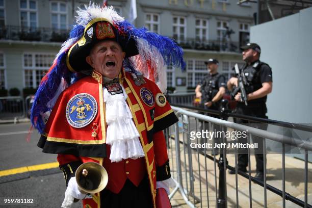 Town crier on the streets as armed police patrol near Windsor castle ahead of the royal wedding of Prince Harry and Meghan Markle on May 18, 2018 in...