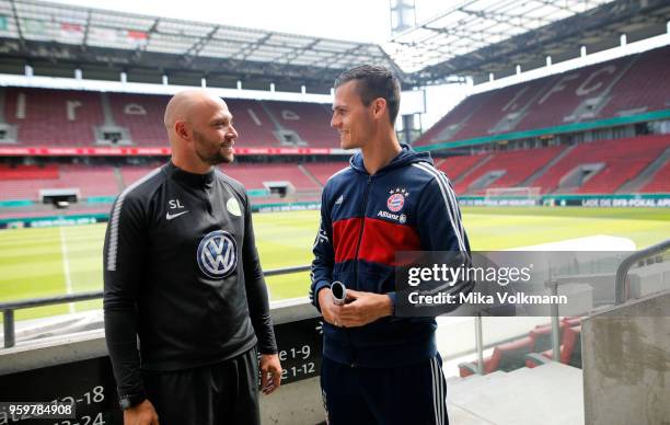 Head coach Stephan Lerch of VfL Wolfsburg talks with head coach Thomas Woerle of Muenchen after the press conference at RheinEnergieStadion on May...