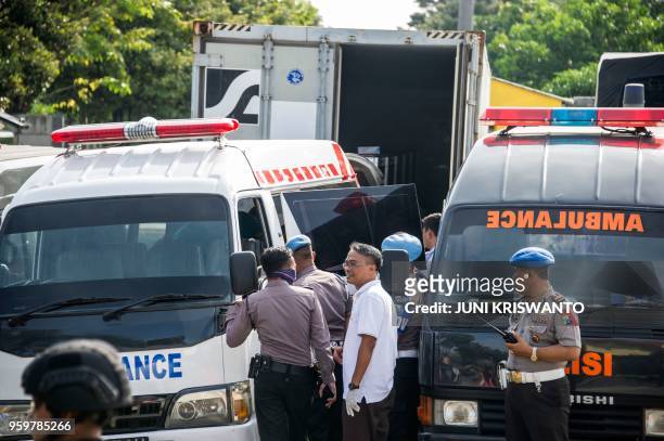 Police transfer the bodies of individuals involved in the Surabaya suicide bombings to ambulances so they can be buried in Surabaya, East Java...