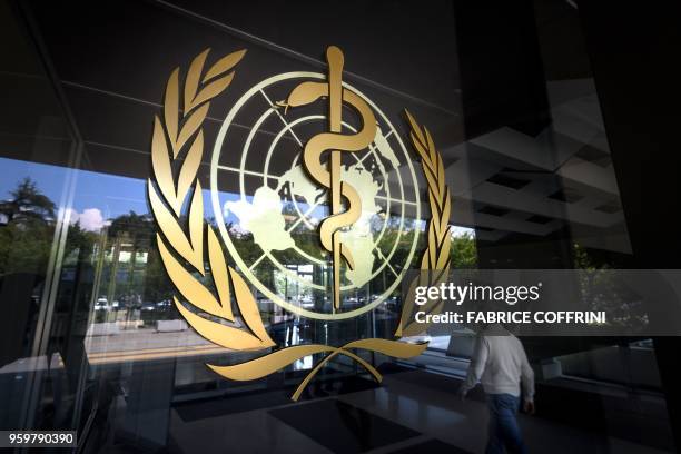 Sign of the World Health Organization is seen at the entrance of the UN specialised agency's headquarters on May 18, 2018 in Geneva. - An Ebola...