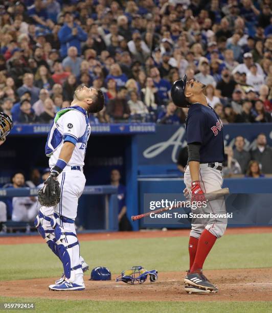 Luke Maile of the Toronto Blue Jays camps underneath a pop up before catching it in the eighth inning during MLB game action as Xander Bogaerts of...