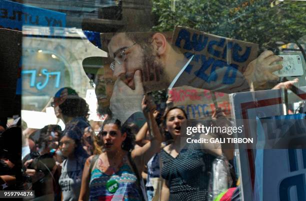 Israeli activists chant slogans, as they carry placards, during the 7th annual SlutWalk march through central Jerusalem on May 18 to protest rape...