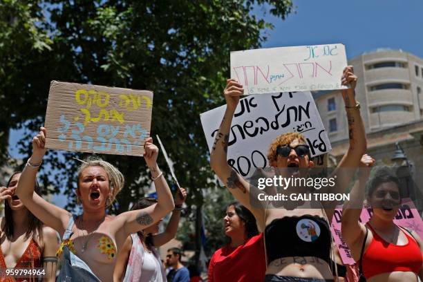 Israeli activists chant slogans, as they carry placards, during the 7th annual SlutWalk march through central Jerusalem on May 18 to protest rape...