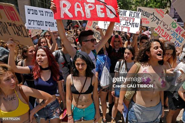 Israeli activists chant slogans, as they carry placards, during the 7th annual SlutWalk march through central Jerusalem on May 18 to protest rape...