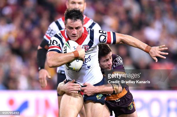 Cooper Cronk of the Roosters takes on the defence during the round 11 NRL match between the Brisbane Broncos and the Sydney Roosters at Suncorp...