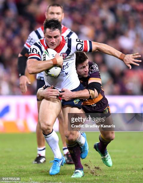 Cooper Cronk of the Roosters takes on the defence during the round 11 NRL match between the Brisbane Broncos and the Sydney Roosters at Suncorp...