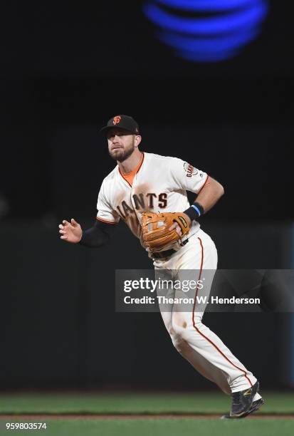 Evan Longoria of the San Francisco Giants reacts to a ground ball hit down the line off the bat of Alex Blandino of the Cincinnati Reds in the top of...