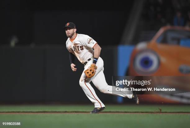 Evan Longoria of the San Francisco Giants reacts to a ground ball hit down the line off the bat of Alex Blandino of the Cincinnati Reds in the top of...