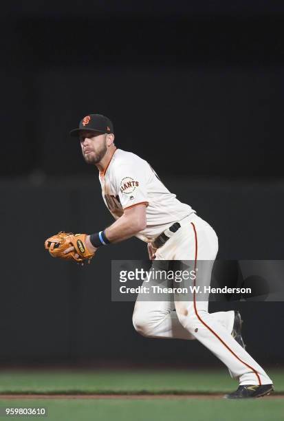 Evan Longoria of the San Francisco Giants reacts to a ground ball hit down the line off the bat of Alex Blandino of the Cincinnati Reds in the top of...
