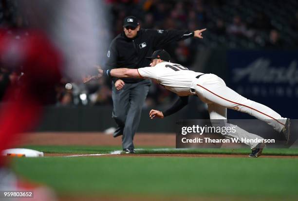 Evan Longoria of the San Francisco Giants dives for this ball that goes down the line for a double off the bat of Alex Blandino of the Cincinnati...